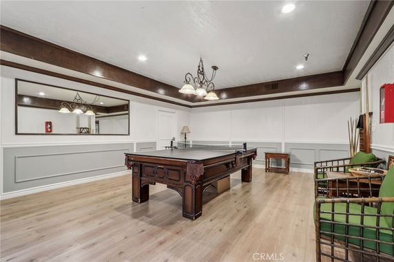 Indoor recreational room with a pool table and seating area.
