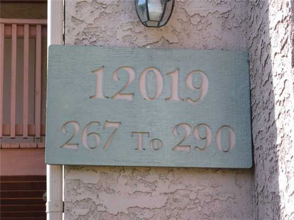 Exterior view featuring a building wall with a numbered sign.