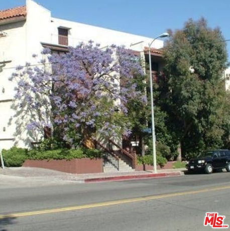 Front view of a multi-story building with a staircase entrance.