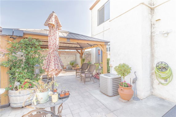 Outdoor patio area with a covered gazebo and seating.