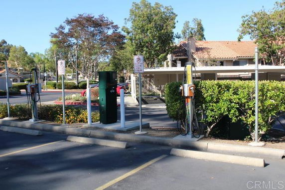 Outdoor parking area with electric vehicle charging stations.