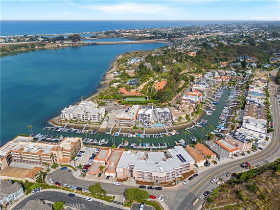 Panoramic aerial view of a coastal area with residential buildings and water channels.