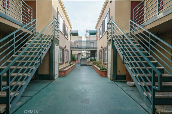 Front view of a two-story apartment complex with exterior staircases.