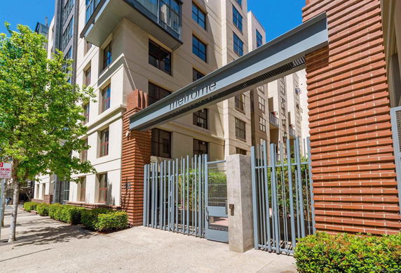 Front view of a multi-story building with a gated entrance.
