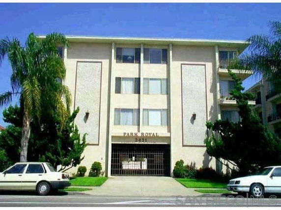 Front view of a multi-story apartment building with a central entrance.