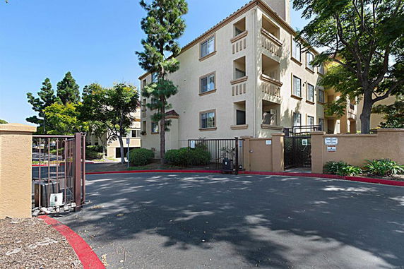 Front view of a multi-story residential building with balconies.