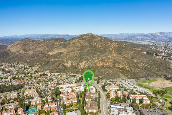 Aerial panoramic view of a residential area with hills in the background.