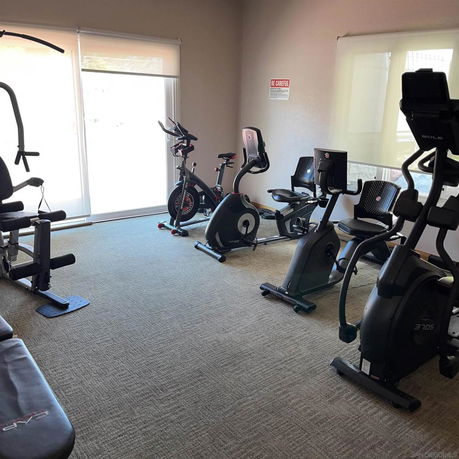 Indoor gym area with exercise bikes and fitness equipment.