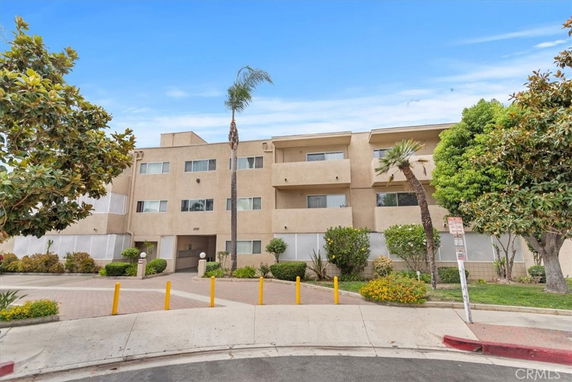 Front view of a multi-story apartment building with a beige exterior.