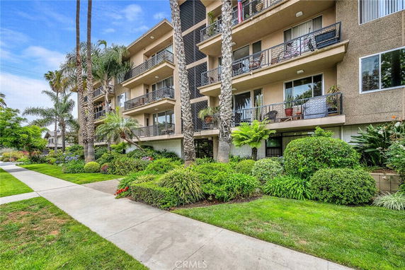 Front view of a multi-story apartment building with balconies.