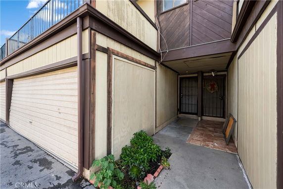 Front view of a house with a garage and entrance area.
