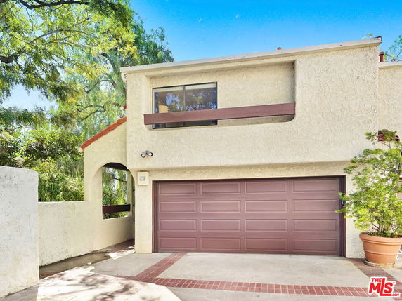 Front view of a two-story house with an attached garage.