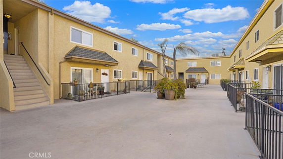 View of a multi-story apartment complex with external staircases and balconies.