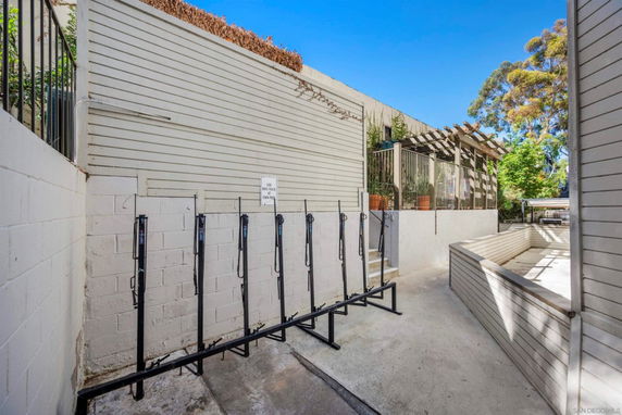 Outdoor area with bike racks and surrounding walls.