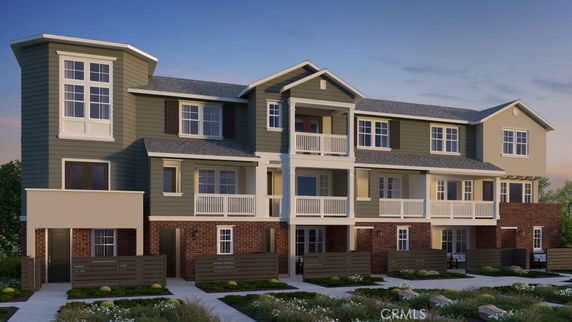 Front view of a three-story residential building with balconies.