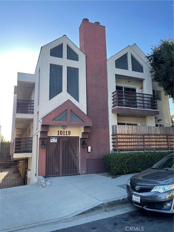 Front view of a multi-story residential building with distinctive architectural design.