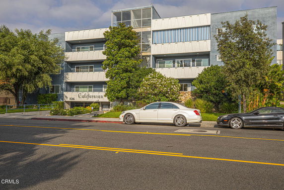 Front view of a multi-story residential building with balconies.