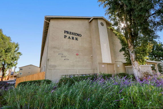 Front view of a multi-story building with text 'Presidio Park' on the wall.