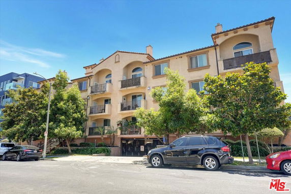 Front view of a multi-story residential building with balconies.