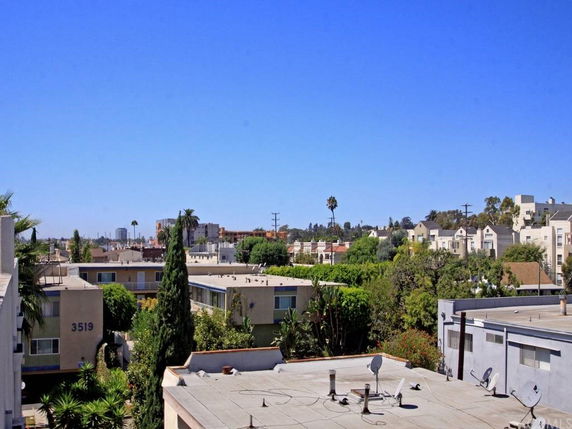 View of surrounding residential area with apartment buildings in the distance.