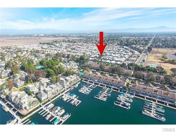 Panoramic view of a residential neighborhood with a marina and boats.