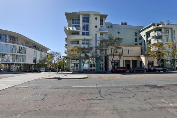 Front view of an apartment building with multiple balconies and a modern design.
