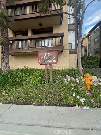 Front view of a multi-story residential building with balconies.