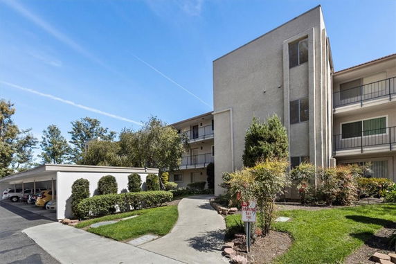 Front view of a multi-story apartment building with balconies.