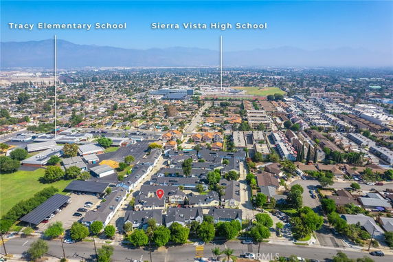 Aerial panoramic view of a suburban area with residential neighborhoods and schools.