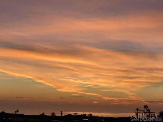 Panoramic view of a sunset with orange and pink sky over the horizon