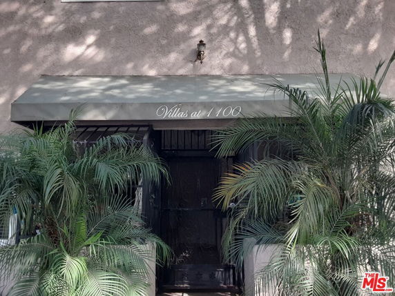 Front view of a building entrance with a sign that reads 'Villas at 1100'.