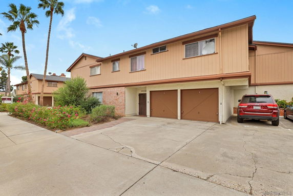 Front view of a two-story residential building with attached garages.