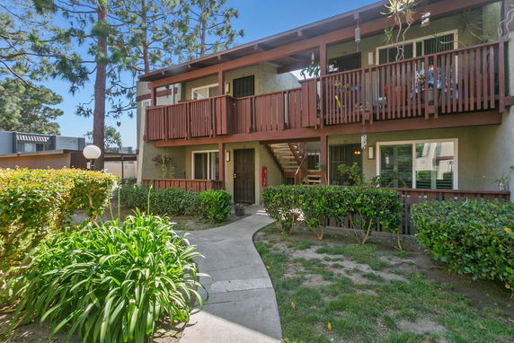 Front view of a two-story residential building with balconies.