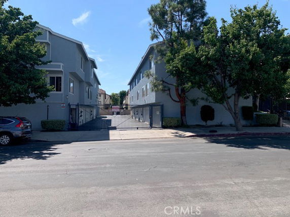 Front view of a residential building with a gated entrance.