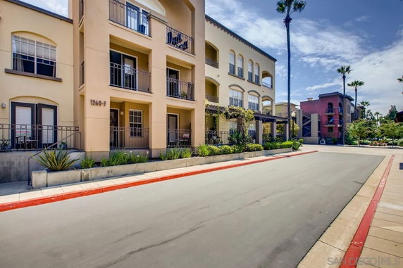 Front view of a multi-story apartment building with balconies.