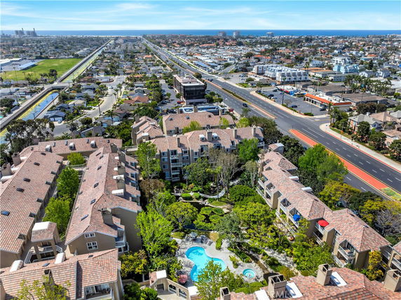 Panoramic view of a residential area with multiple buildings and surrounding cityscape.