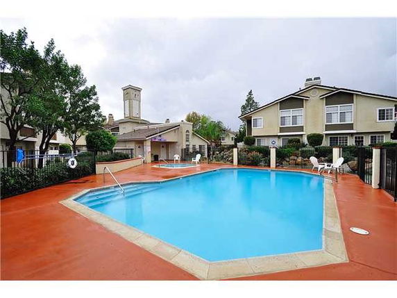 Outdoor swimming pool area surrounded by residential buildings.