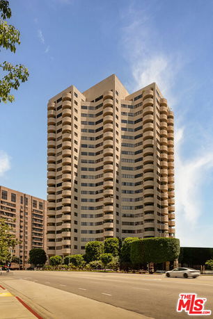 Front view of a multi-story residential building with balconies.