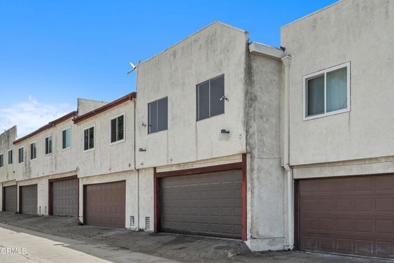 Front view of a multi-unit building with garages.