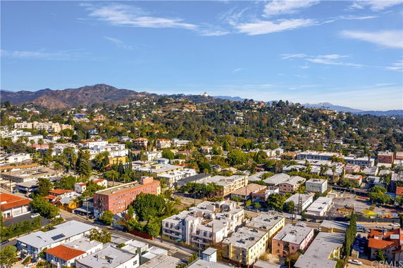 Panoramic view of a hillside suburb with a mix of residential buildings.