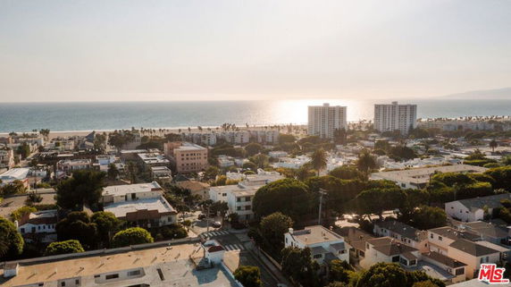 Panoramic view of a coastal cityscape with buildings and ocean in the background.