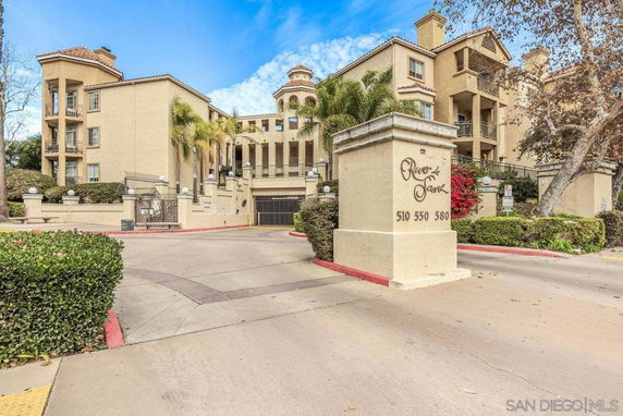 Front view of multi-story residential building with gated entrance.