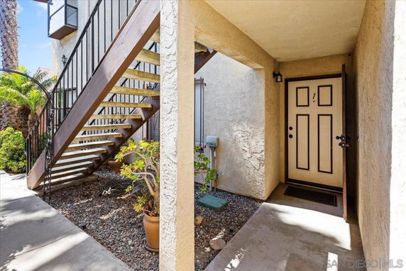 View of an exterior staircase leading to the entrance of a residential unit.