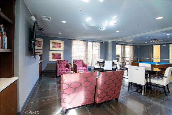 Clubhouse interior with seating area and pool table.