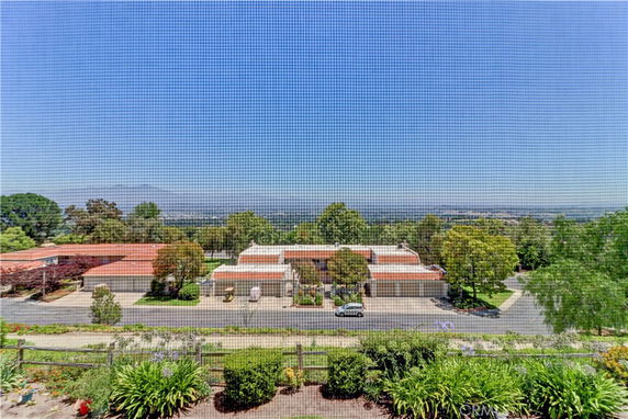 Panoramic view of buildings with red roofs and surrounding greenery.