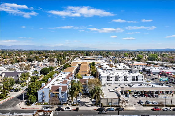 Panoramic view of urban buildings with residential and commercial areas in the foreground.