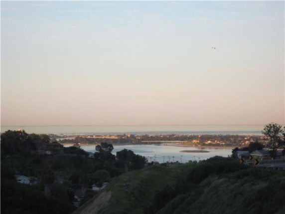Wide angle view of a landscape with water bodies and distant islands.