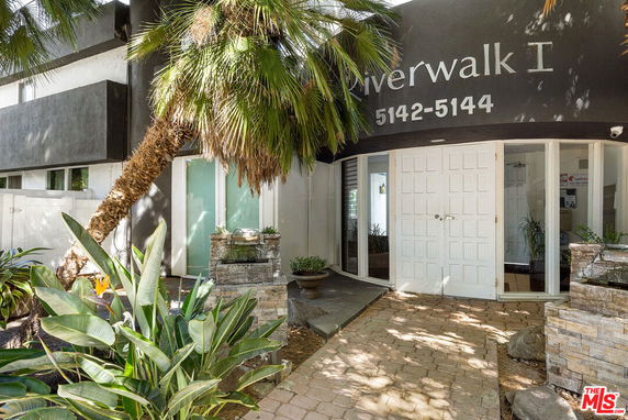 Front view of a building with the name 'Riverwalk I' and double doors.