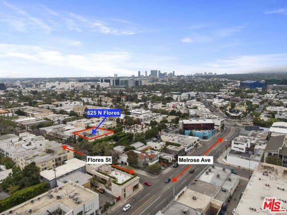 Panoramic view of a cityscape featuring streets and multiple buildings.