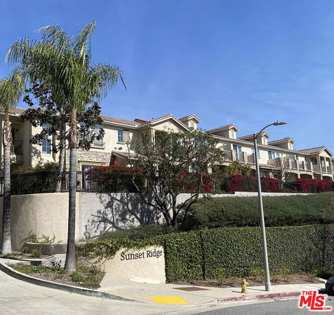 Front view of a multi-story residential building complex.